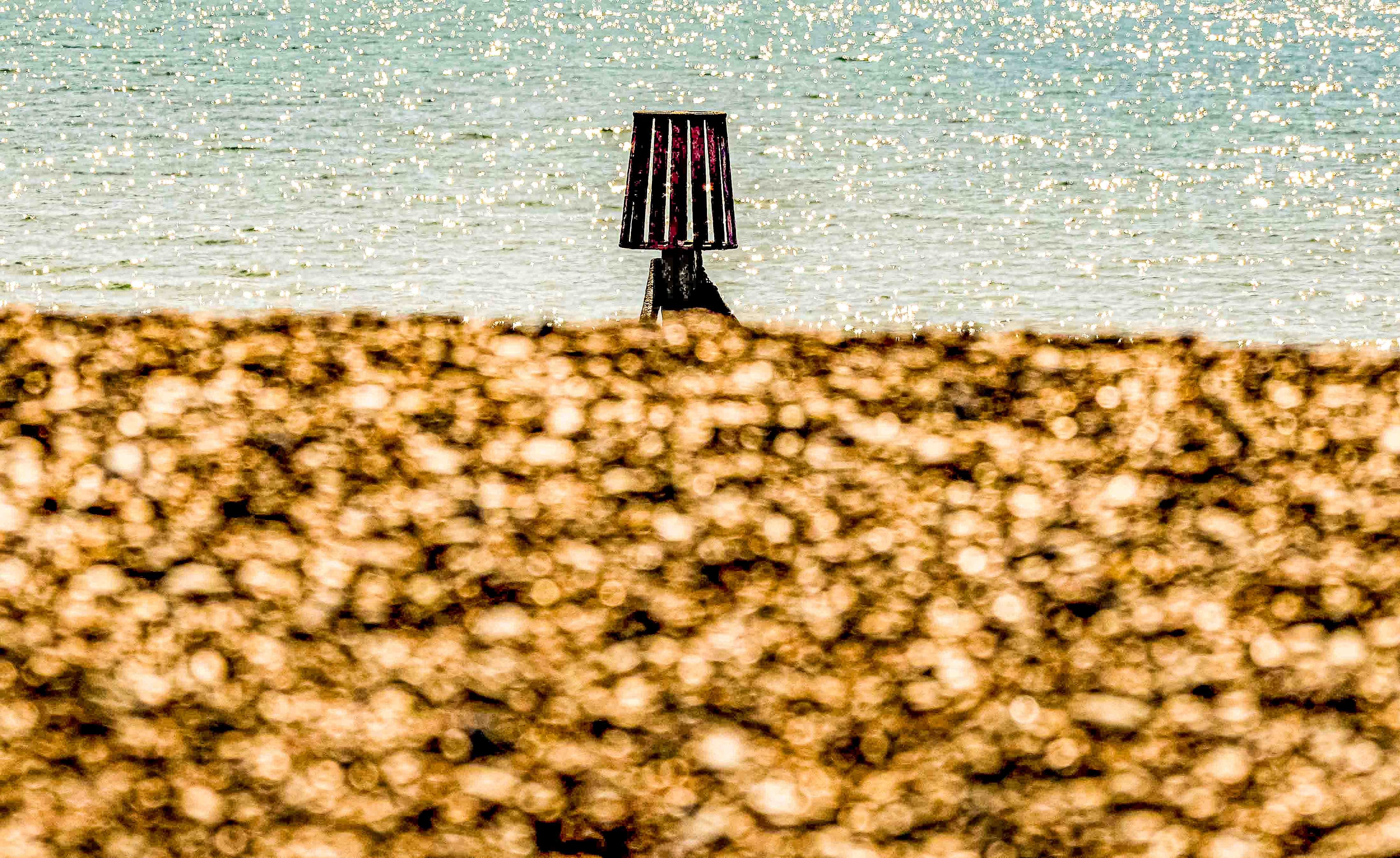 Beach 26 — green lamp post, blue sky, distant figures